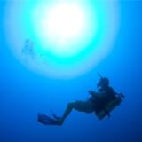 Scuba instructor demonstrating buoyancy