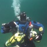 Technical scuba divers hovering through the deep waters